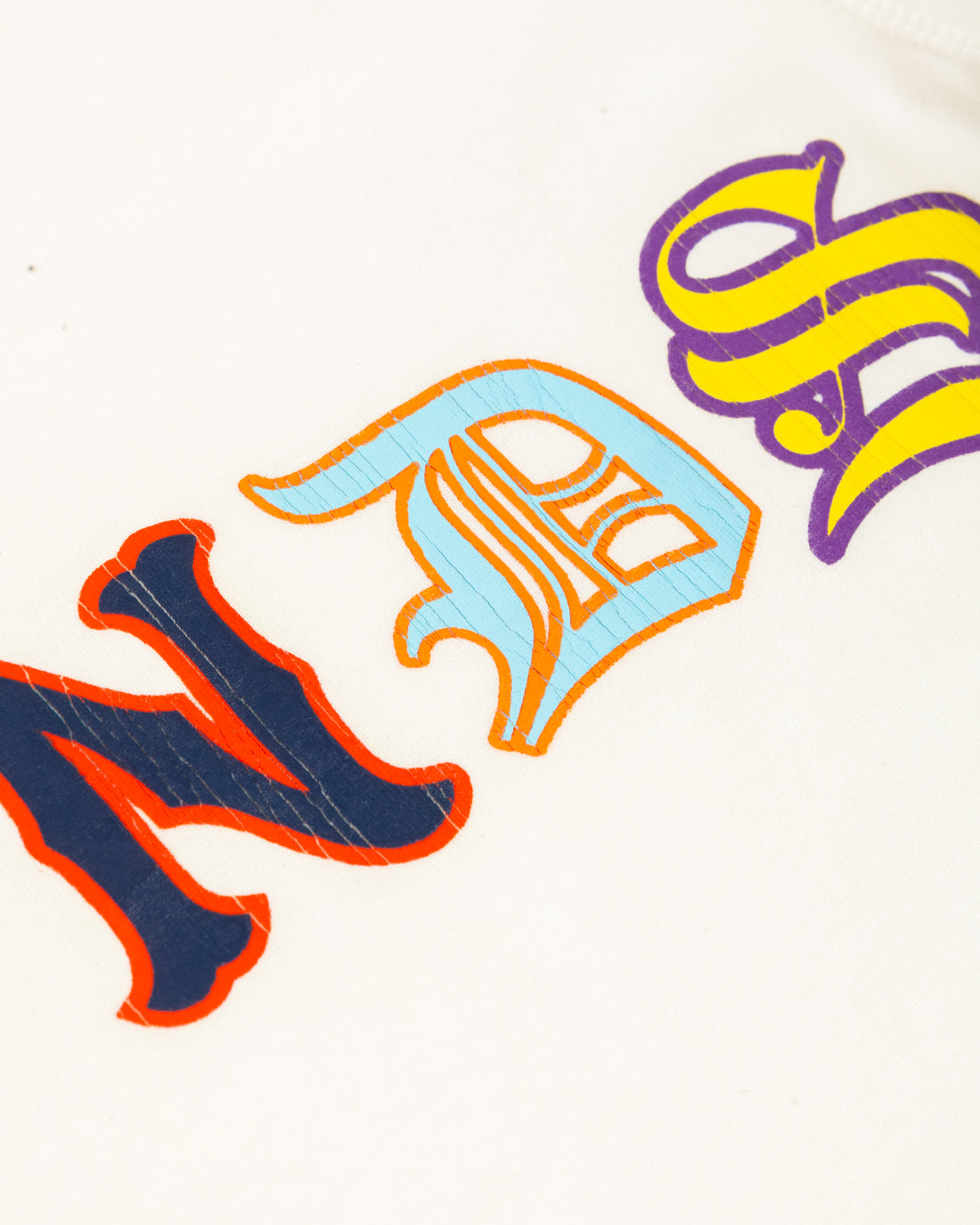Close-up of the textured Friends lettering on the white Vintage Friends Tee